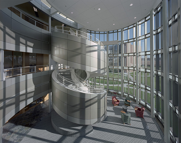 The University Center of Lake County exemplifies the malleability of metal panels. The south façade, which embraces the courtyard, features metal bands that weave in and out of the curtain wall to create balconies and bay windows. The bands carry through to the interior to define the atrium balconies and a spiral staircase.
