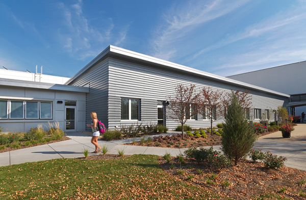 Two different types of metal cladding define the offices (left, smooth metal) and shop area (right, corrugated metal) at Joliet Junior College’s Facility Maintenance Building.