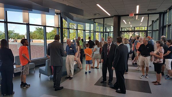 Community members tour the third-floor glass bridge.