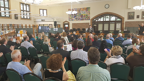 Dr. Peter Monaghan, Principal of Glenbard West, offers introductory remarks in the school’s library.