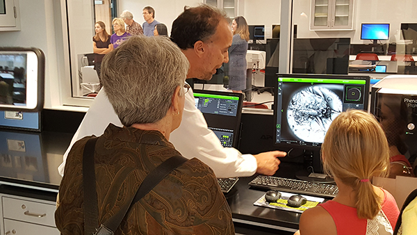 In the STEM Lab’s “Nano Nook,” science teacher Joe Maxwell uses the scanning electron microscope to show guests the ligaments of a magnified insect.