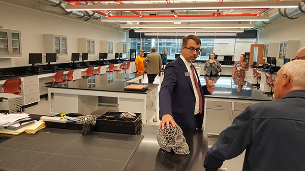 MHS Principal Dr. Anthony Kroll discusses a skull that students made using the 3D printer in the Project Lead the Way Lab.