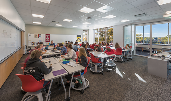 Second floor classrooms access breakout space (right) with movable glass walls.