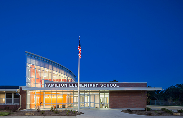 A curtain wall marks the point at which the new Hamilton Elementary School begins and creates a circulation pattern for the entire building as it curves around the facility.