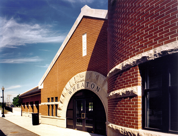 Warm red brick and stone arches have helped make the Metra train station in Wheaton, Illinois a community centerpiece.