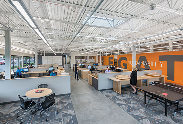 The central work area supports teamwork and recreation amid an open setting filled with natural light.