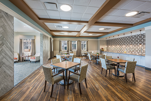 An intimate dining space called The Harvest carries over the wall tile pattern from the renovated main dining area. The faux framing wood on the ceiling helps create the soft, natural look that Generations at Neighbors wanted.