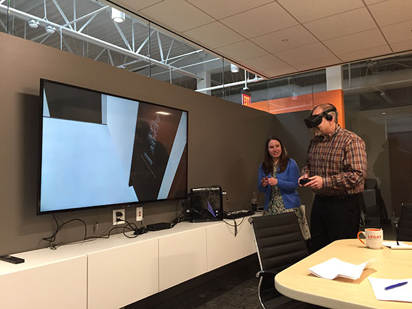 In Legat’s Gurnee studio, Sarah Garthaus of IMEG Corp, the project’s structural engineer, gives BGPD Executive Director Ryan Risinger a virtual reality tour of the revived spaces.