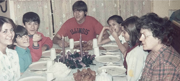 Family sitting around a table and having a meal