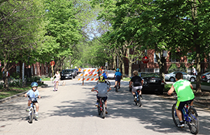 children riding bikes on city street