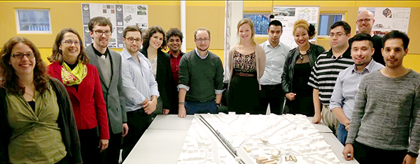 architecture teacher and students surrounding a site plan