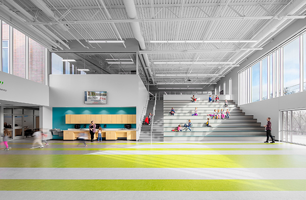 school atrium with bright flooring, natural light, and staircase