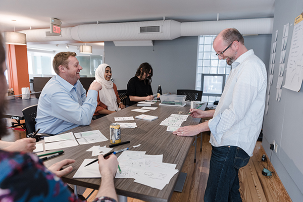 Legat Director of Design Evan Menk (right) leads an exercise with staff.