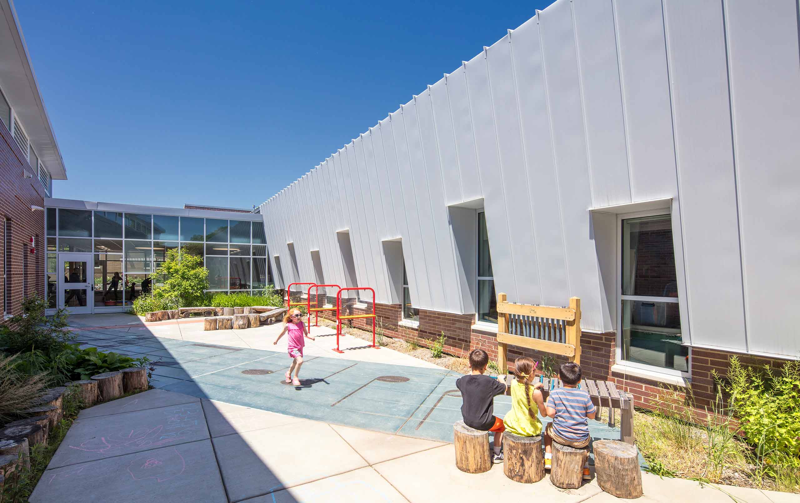 CCSD59 ELC kids playing outside in art-themed courtyard