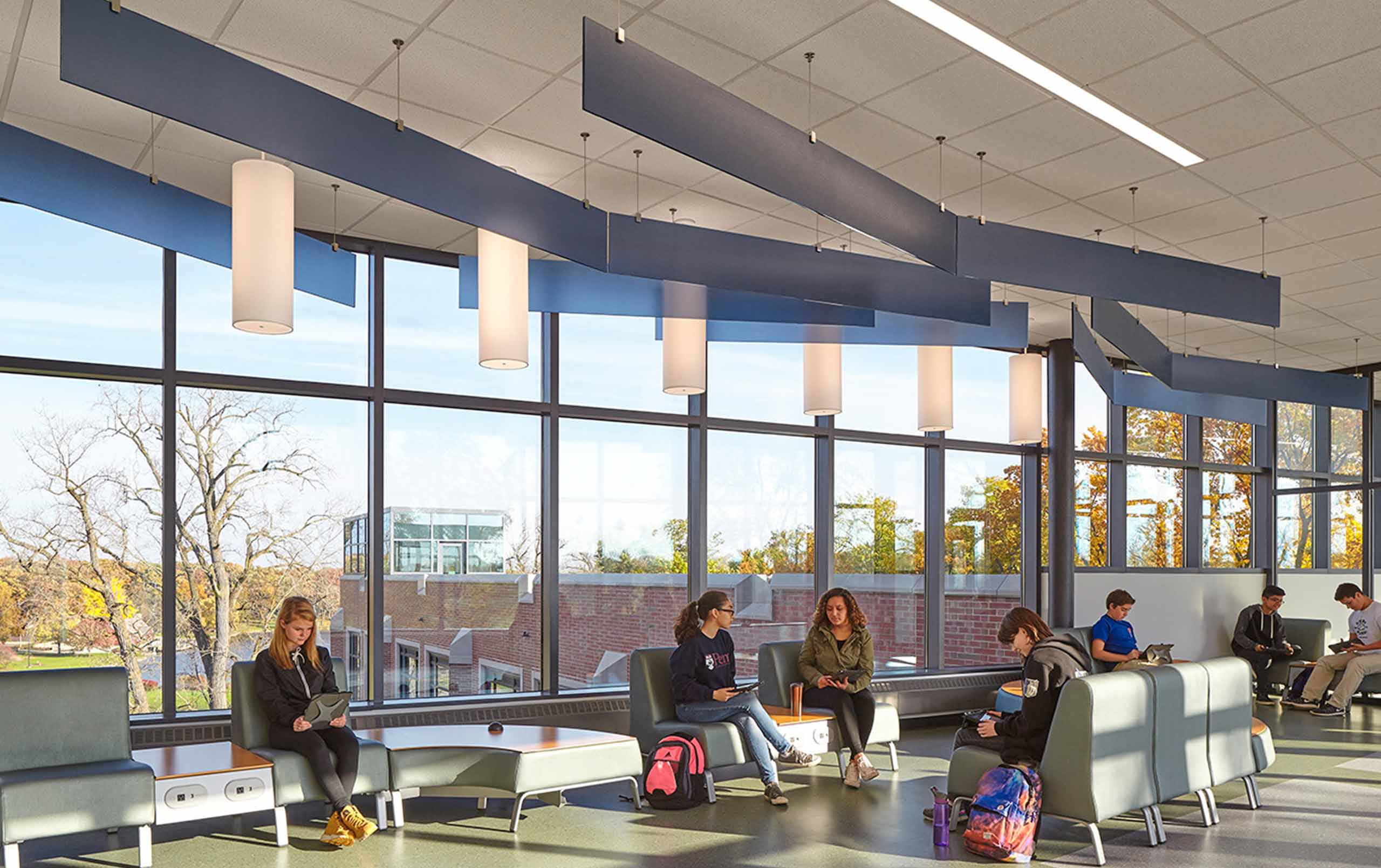 Students collaborating in bright corridor in Glenbard West High School