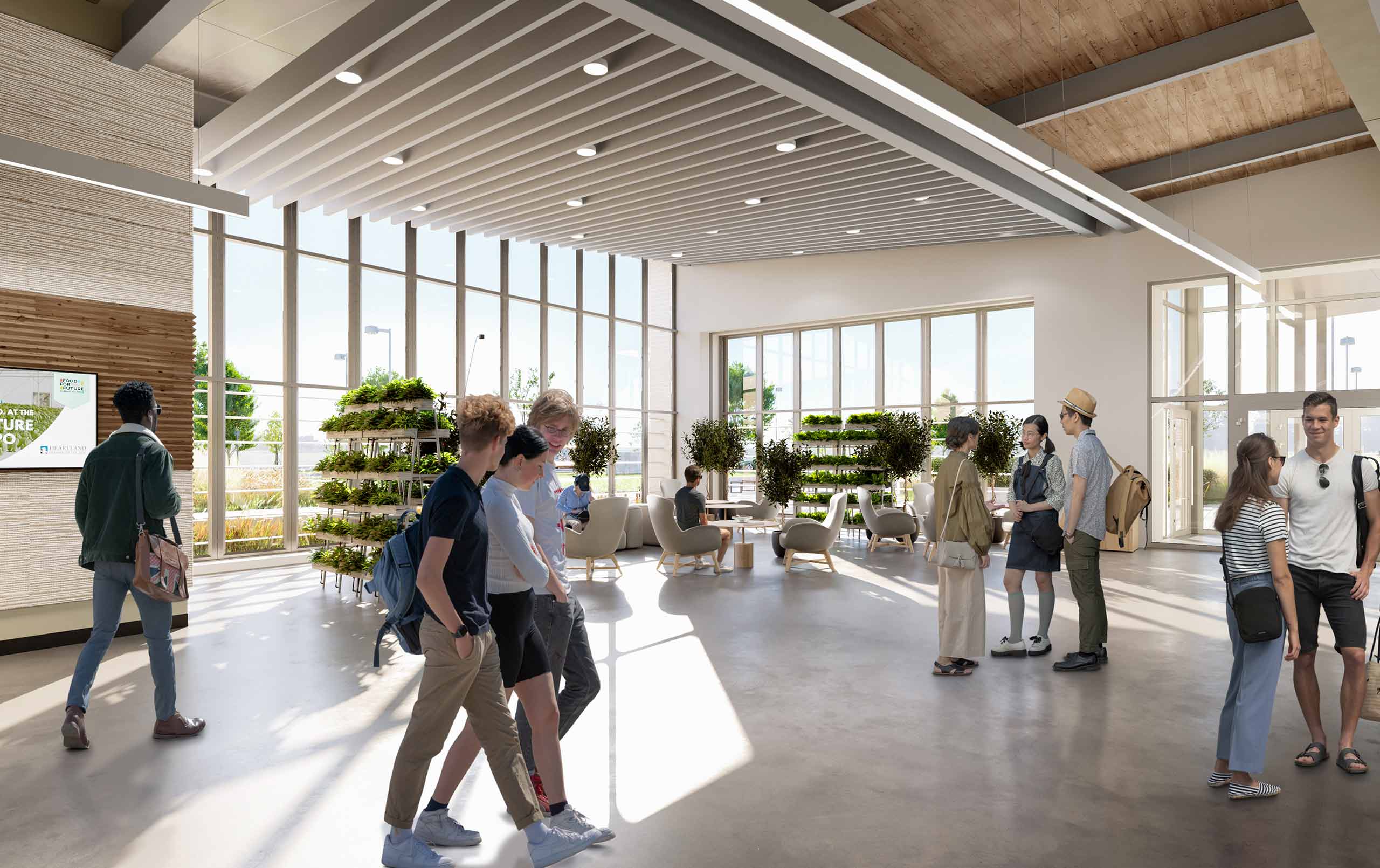 Young adults collaborating in light-filled lobby at Heartland Community College Net Zero Agricultural Complex