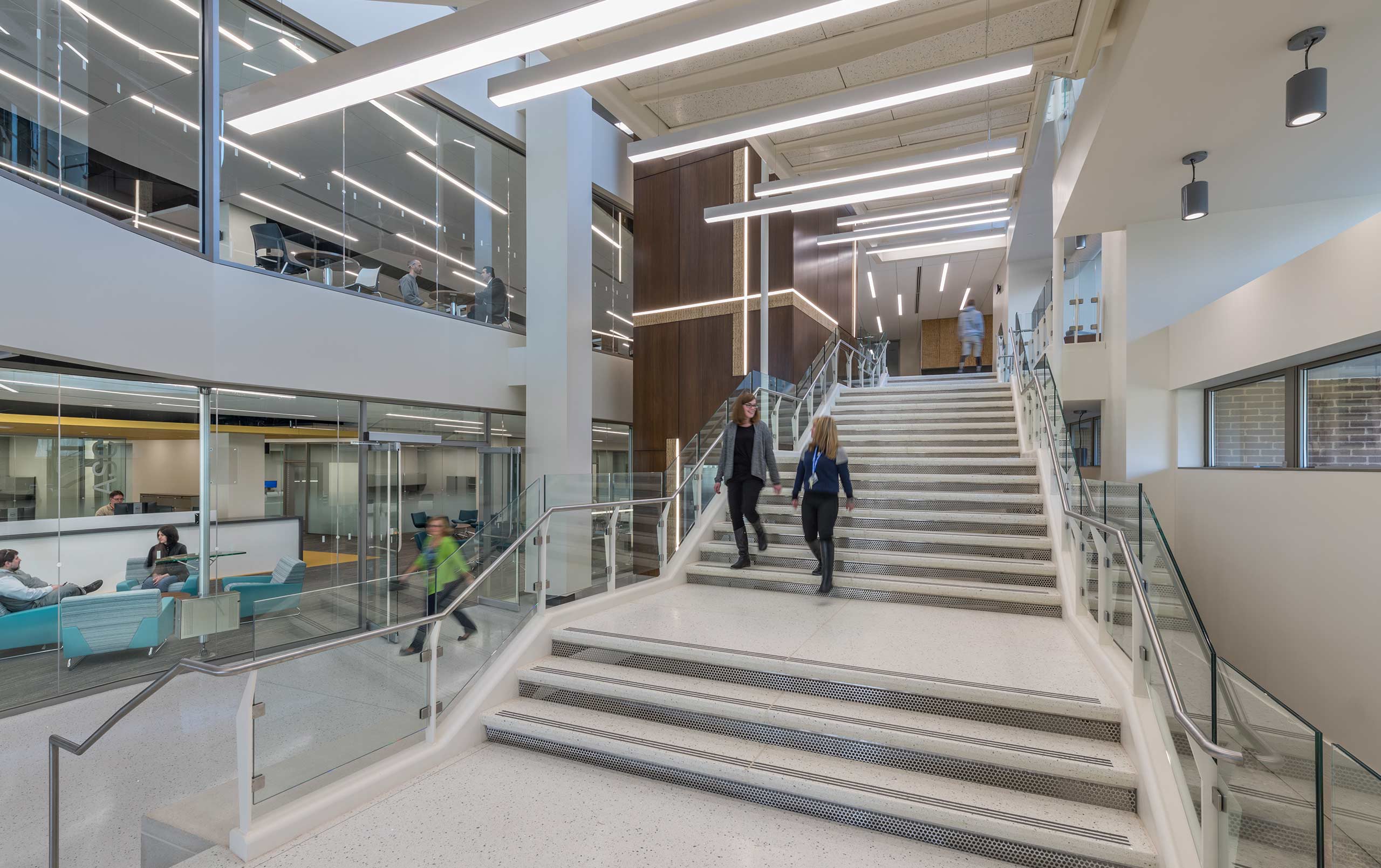 Staff using Harper College library staircase.