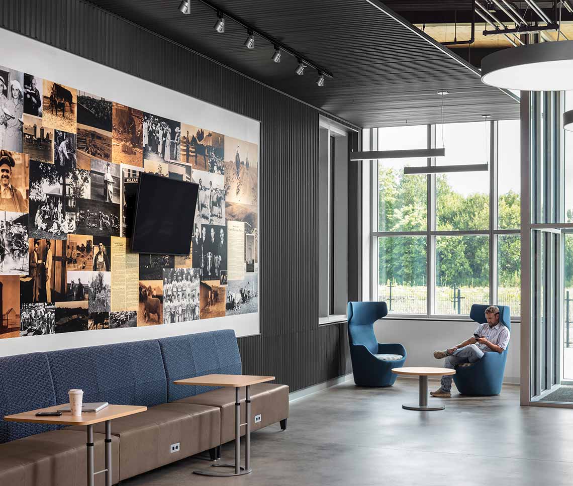 College corridor with wall collage, student seated by window