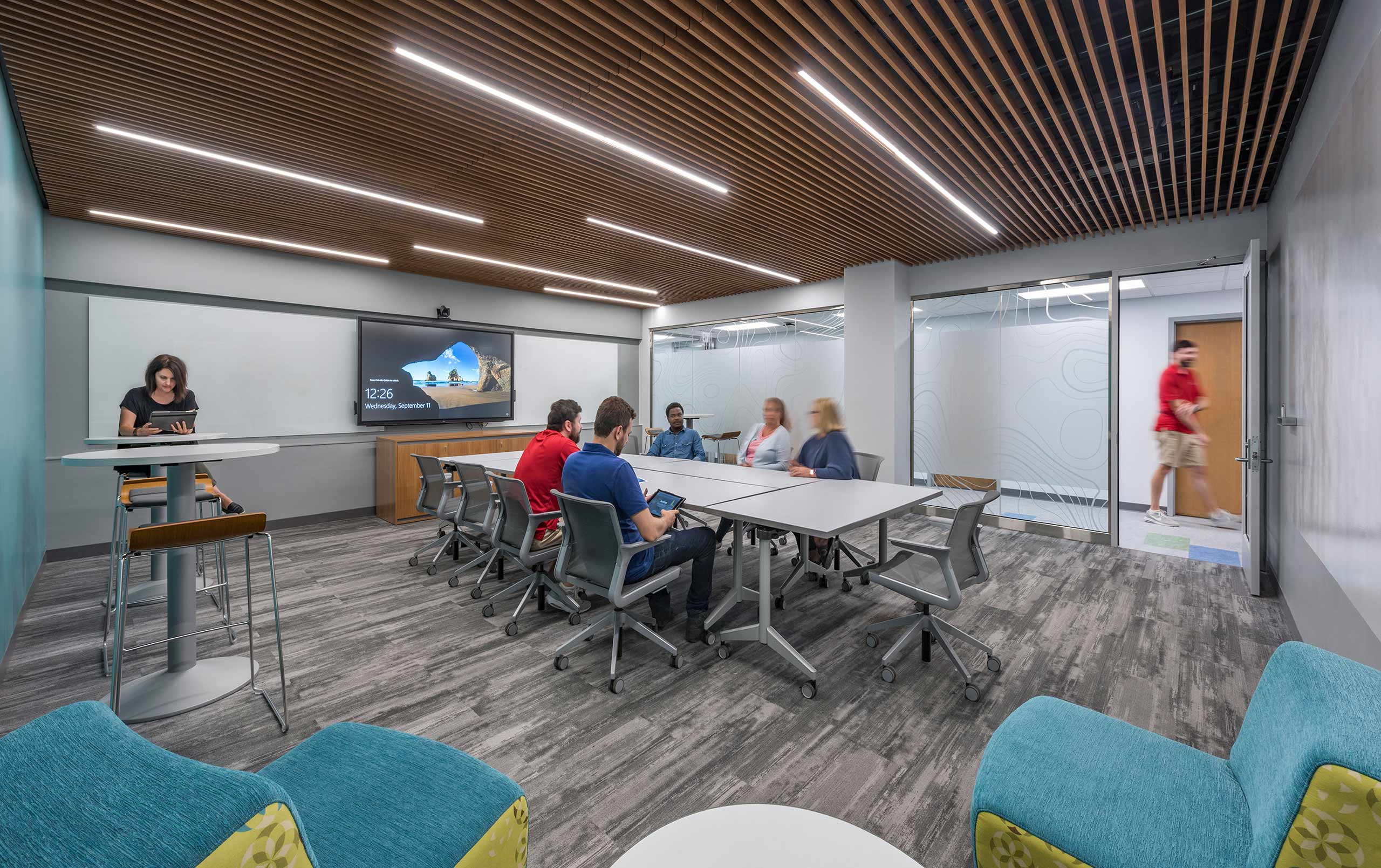 Students collaborating in conference room.