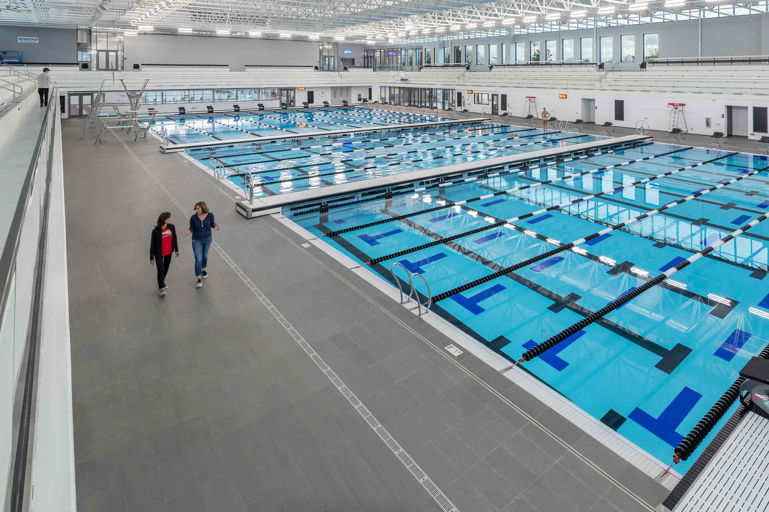 two ladies walking indoors aquatic center