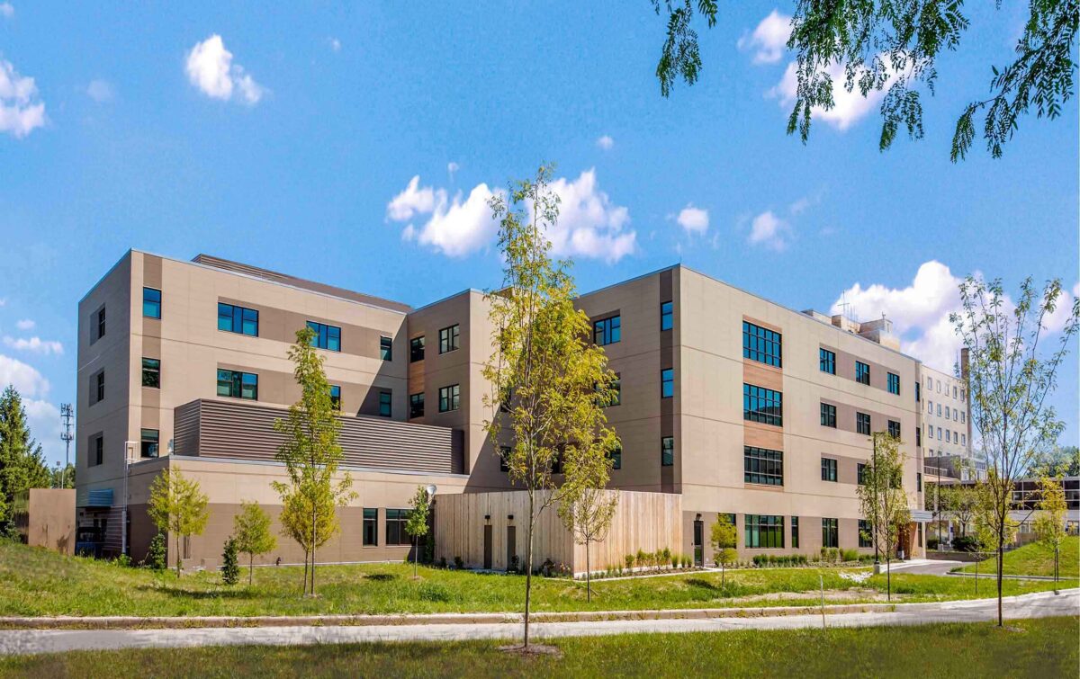 Exterior view of behavioral health hospital with small trees in foreground