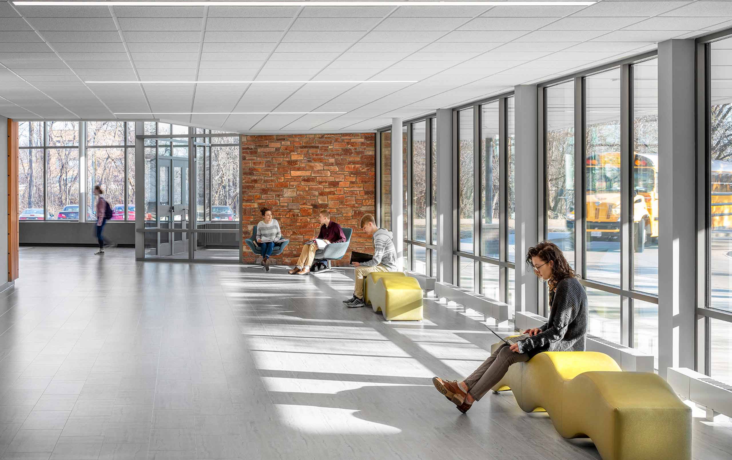 A group of students collaborating in the Moline High School main entrance corridor. 