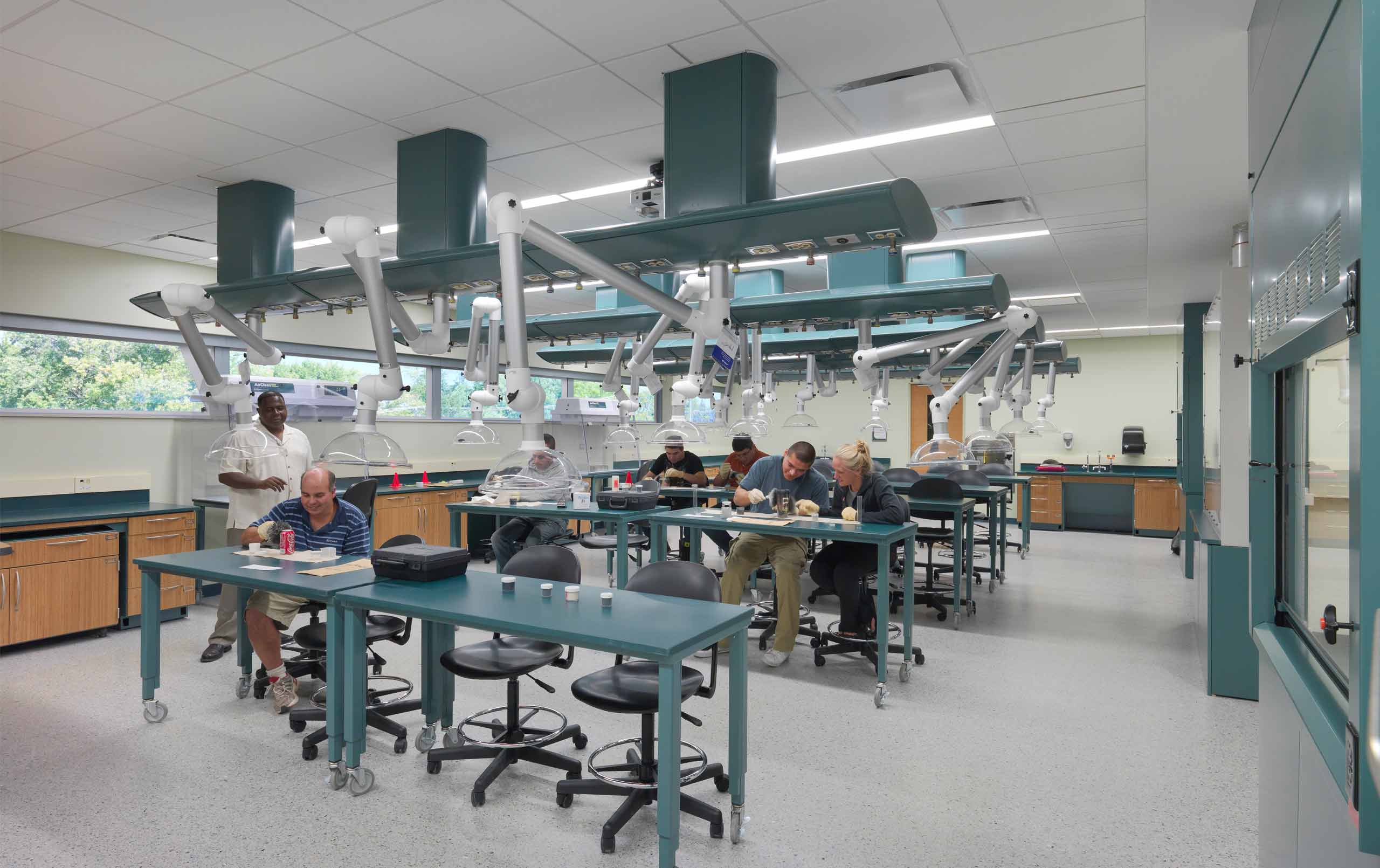 Students examining evidence in higher education forensics lab