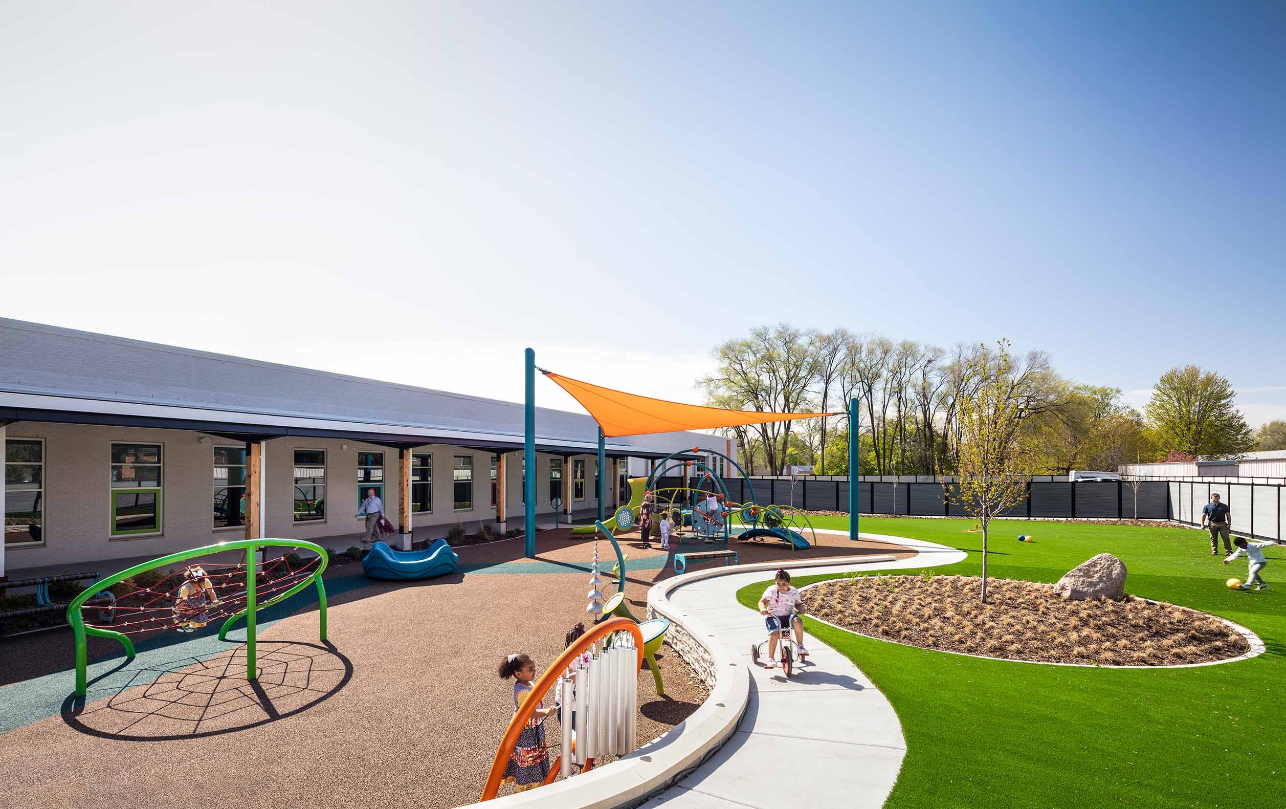 Students doing a variety of activities on preschool playground