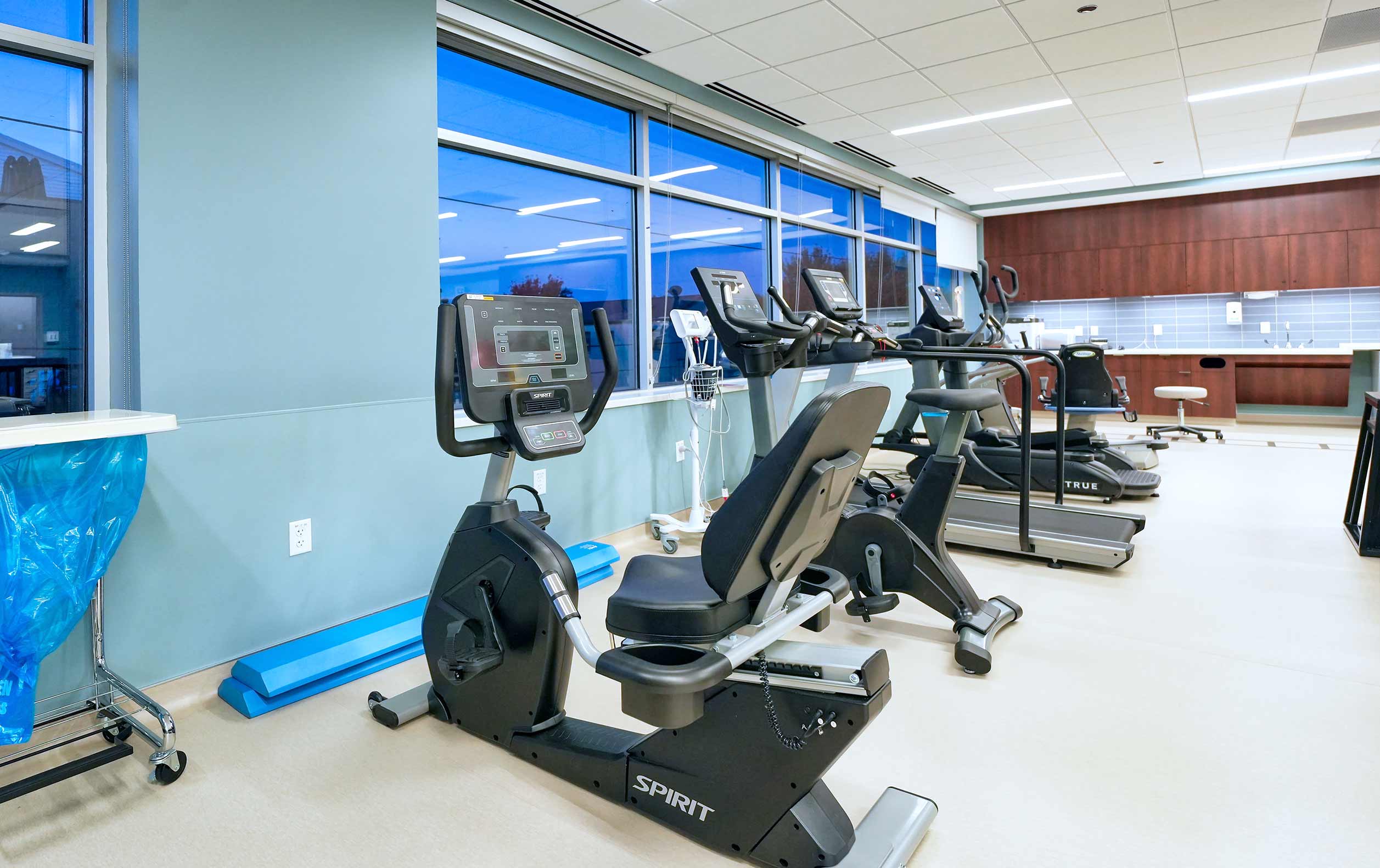 Physical therapy room with bikes and large windows