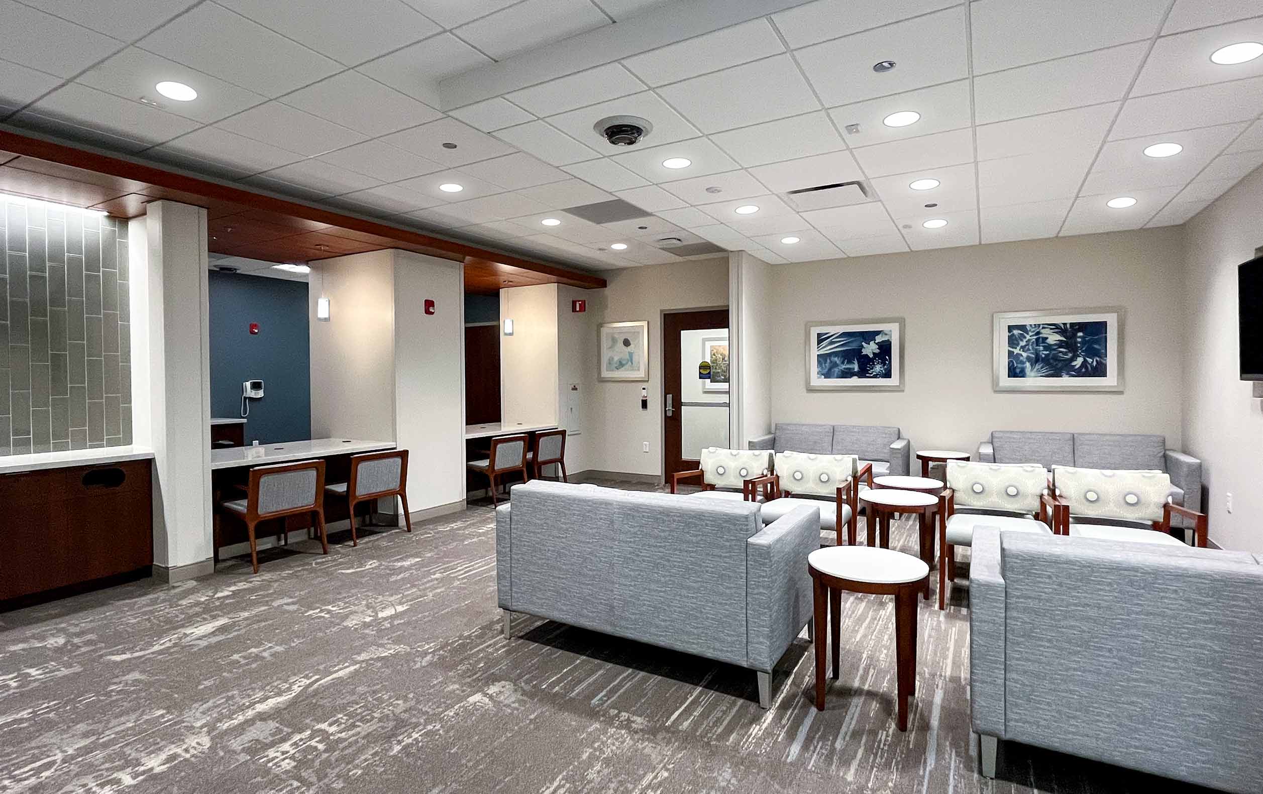 Medical office waiting lobby with chairs, couches, and check-in booths