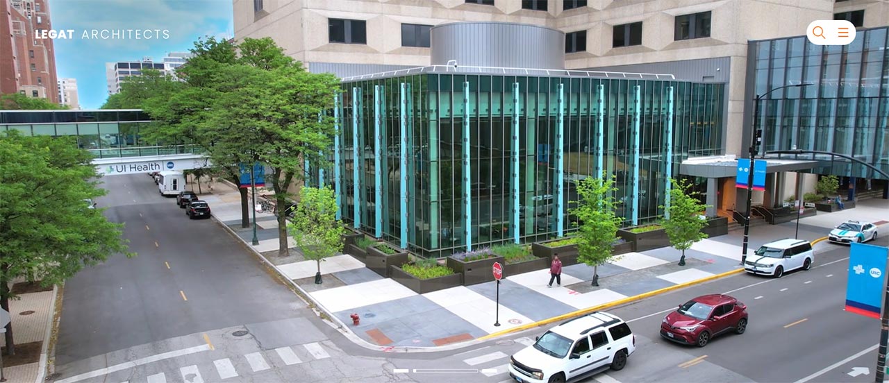 Website homepage showing aerial view of building with glass wall