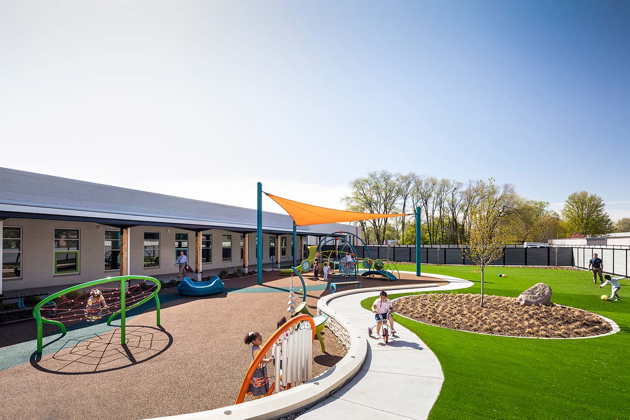 Playground with equipment on left and grassy area on left