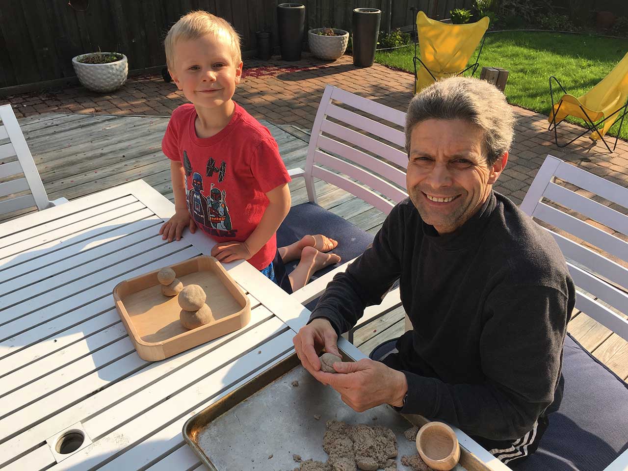 Boy and uncle sculpting sand