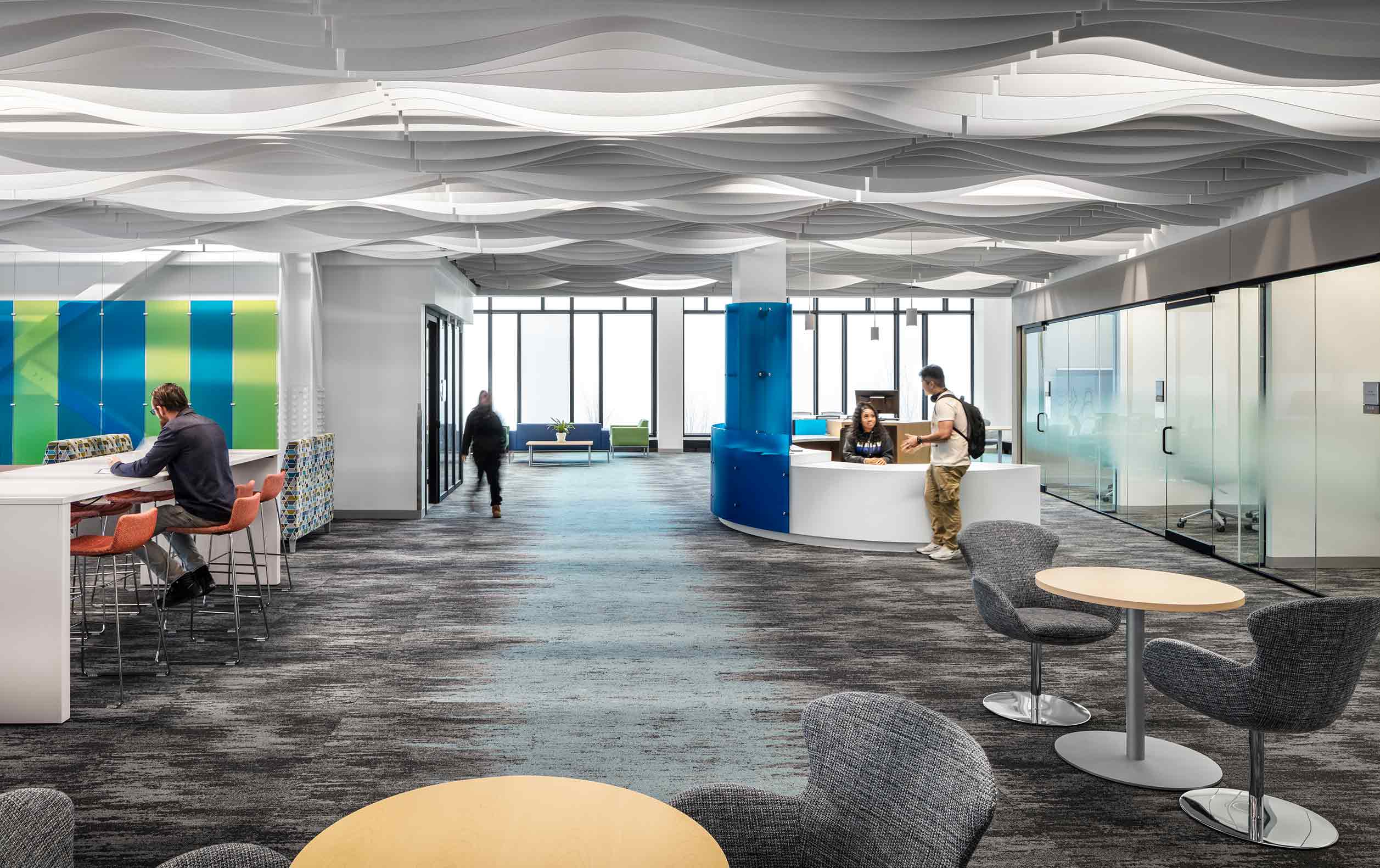 Library with wavy ceiling baffles and green and blue highlights