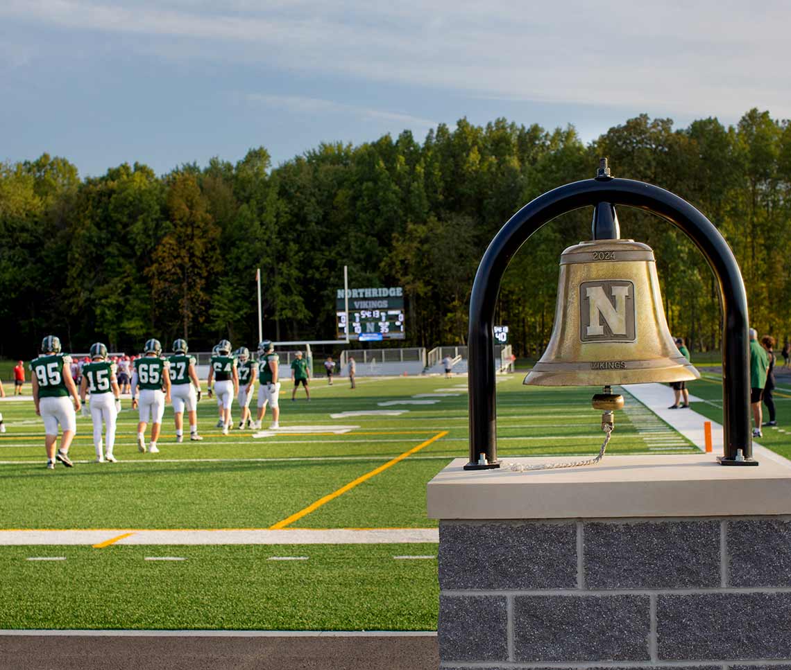 Northridge High School Ohio stadium with bell in foreground and football field in background
