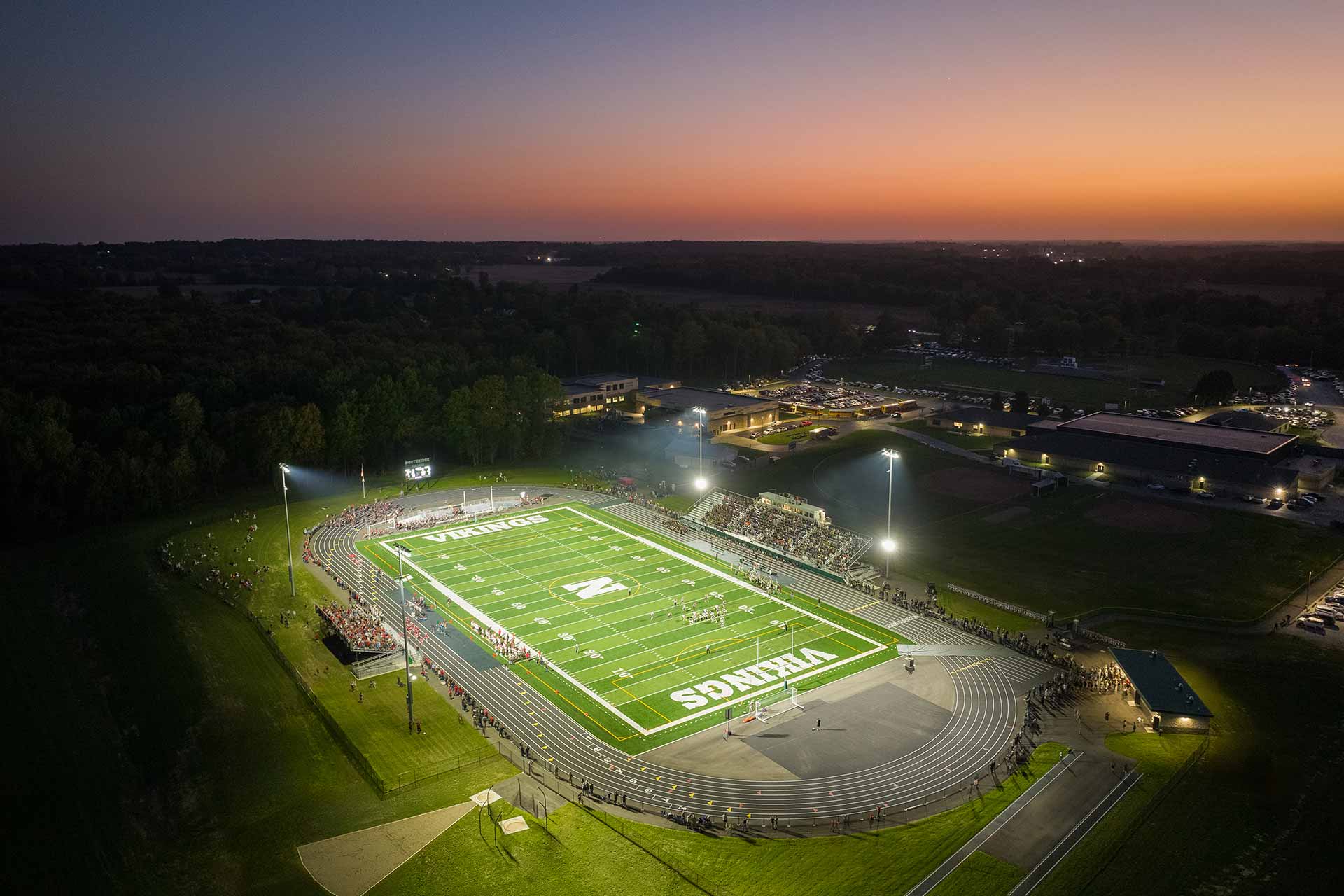 Nighttime aerial view of high school football stadium