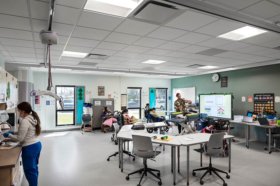 Teachers and students in a special needs classroom.