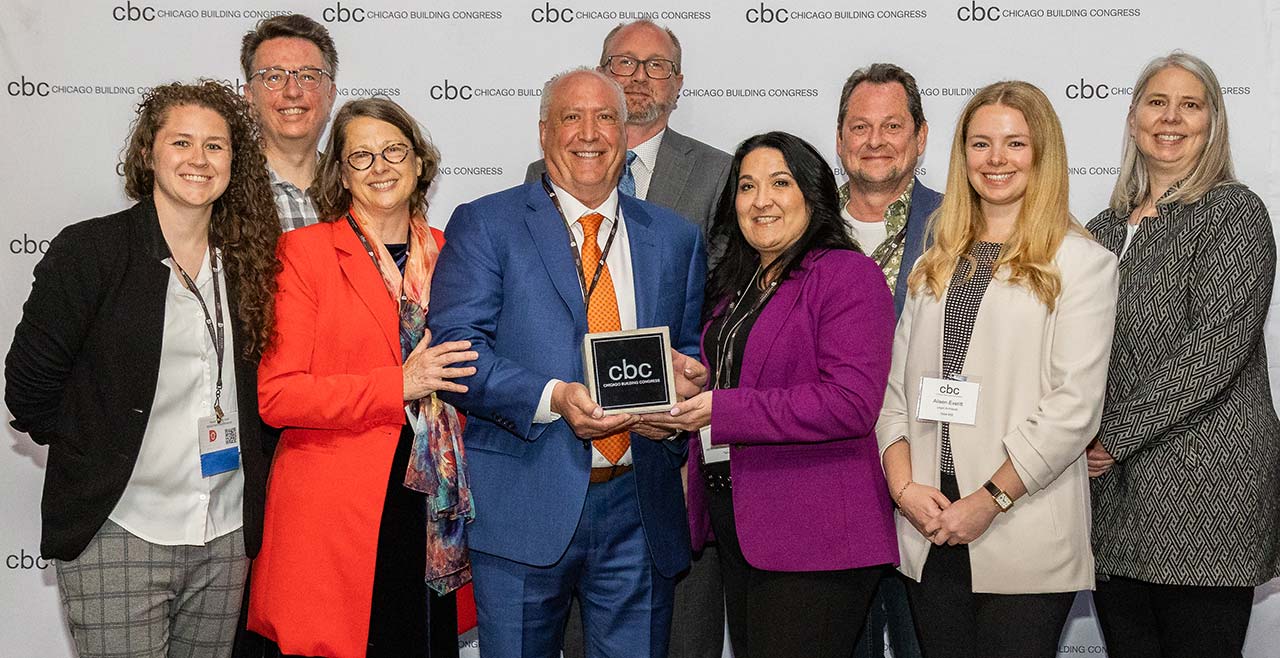A.E.R.O., Legat, and IHC representative holding the 2025 CBC Merit Award.