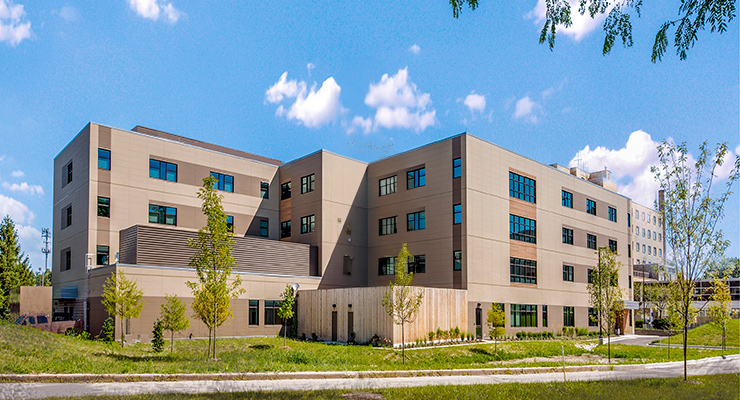 Behavioral health hospital with blue sky and trees
