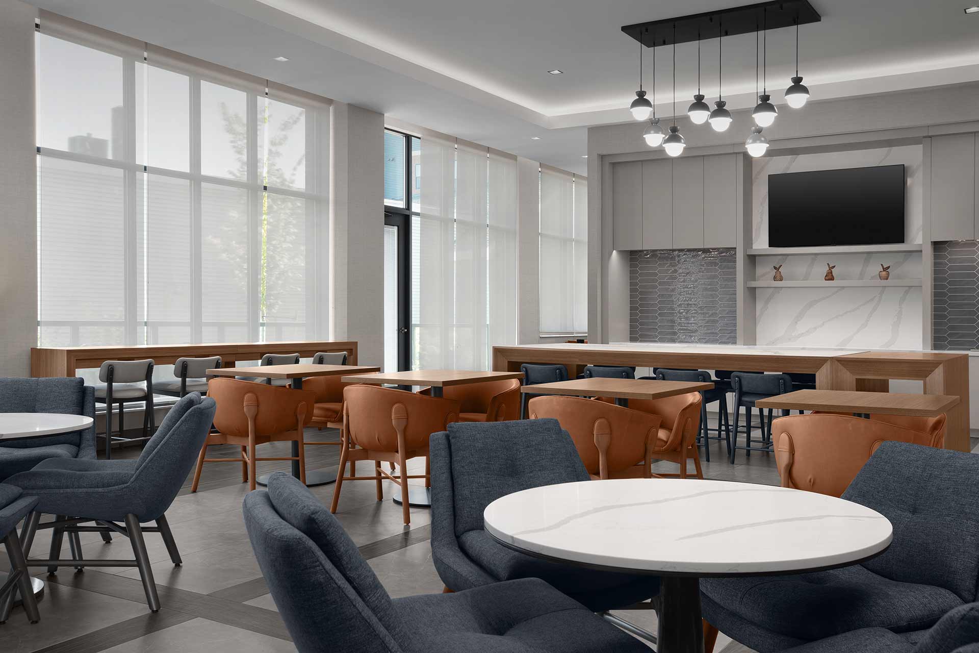 Hotel breakfast seating area with tables and high-top seating