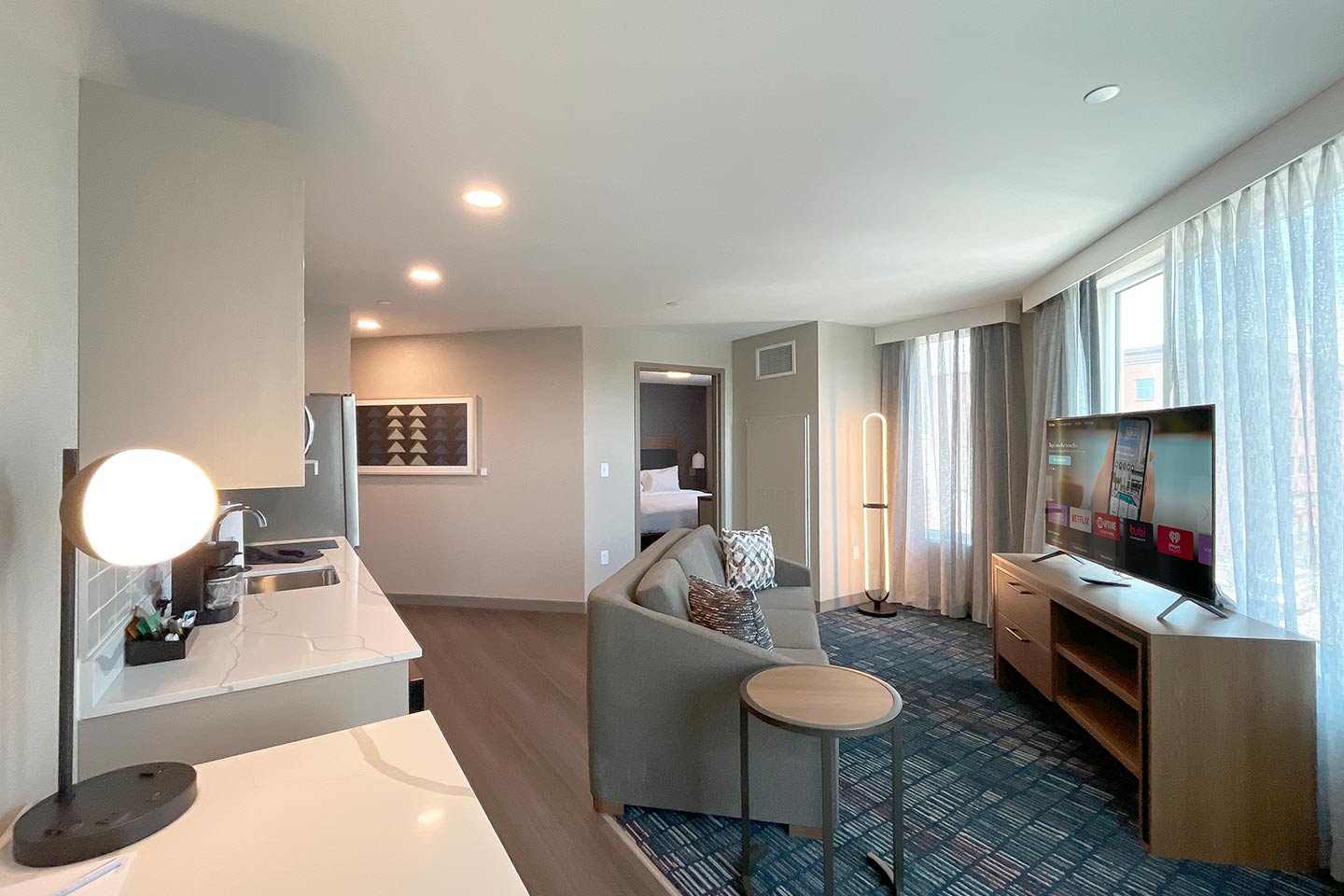 Hotel extended stay suite with sink, couch, TV