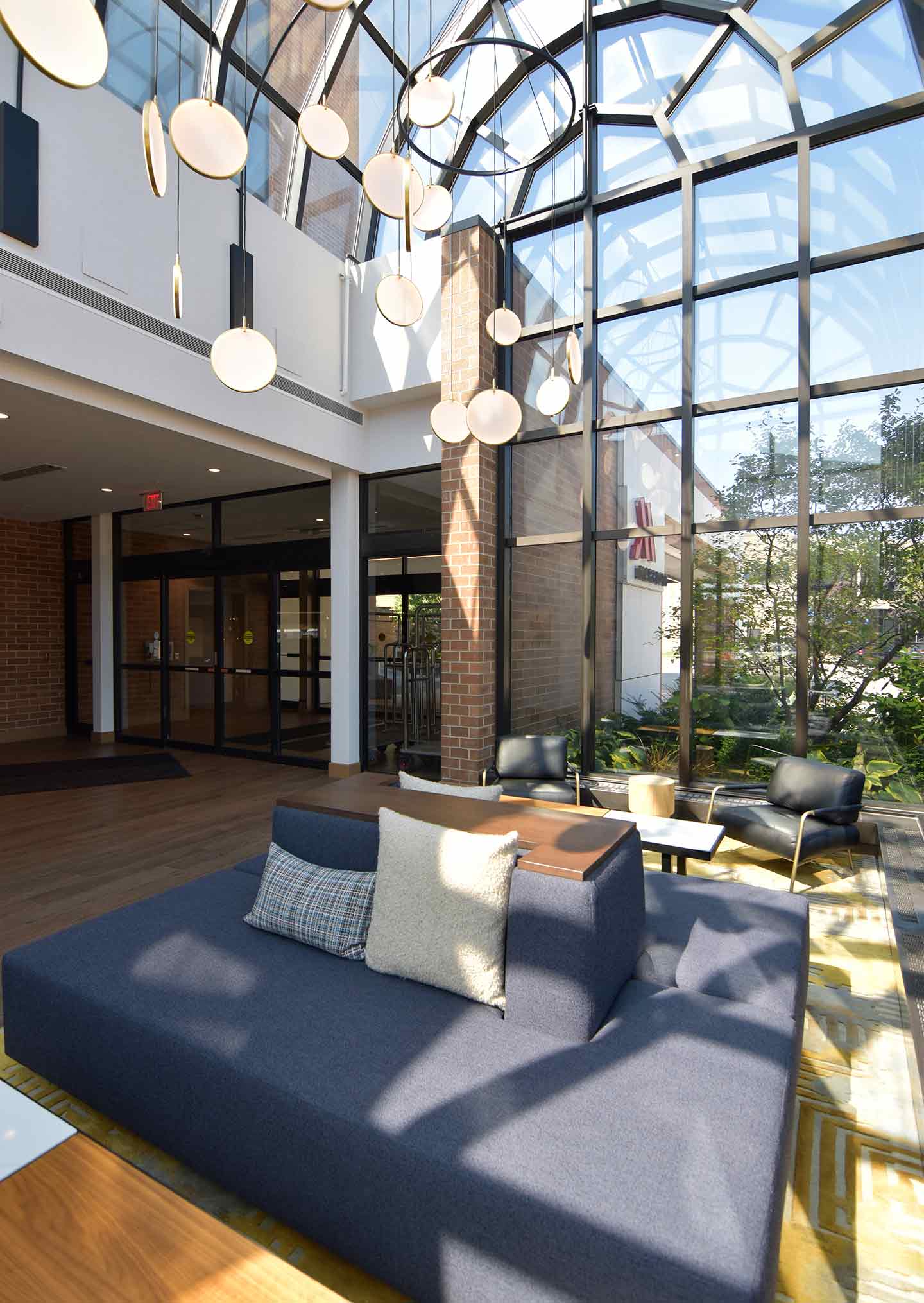 Sunny hotel lobby with large window wall