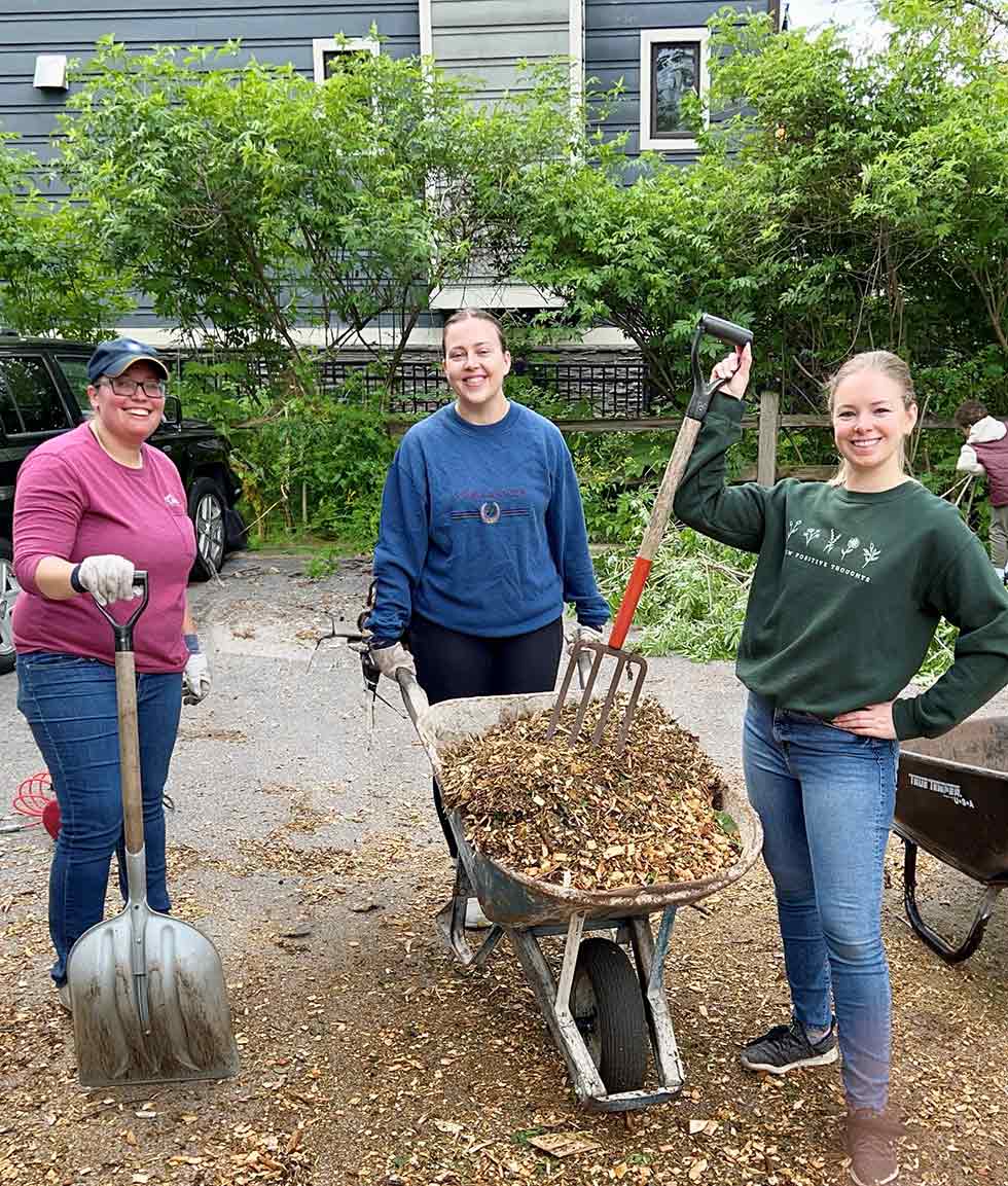 Volunteers with wheelbarrow