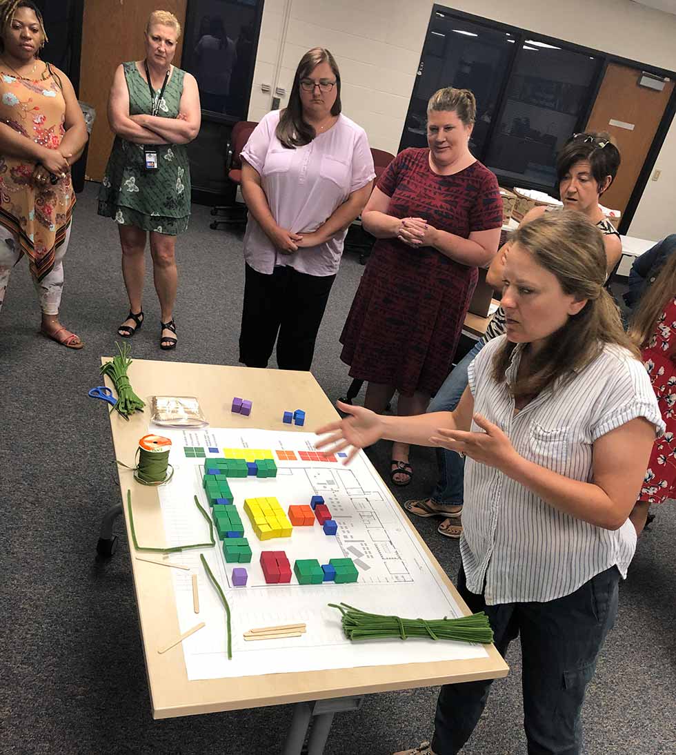 Teachers and parents working on a plan for a new school.