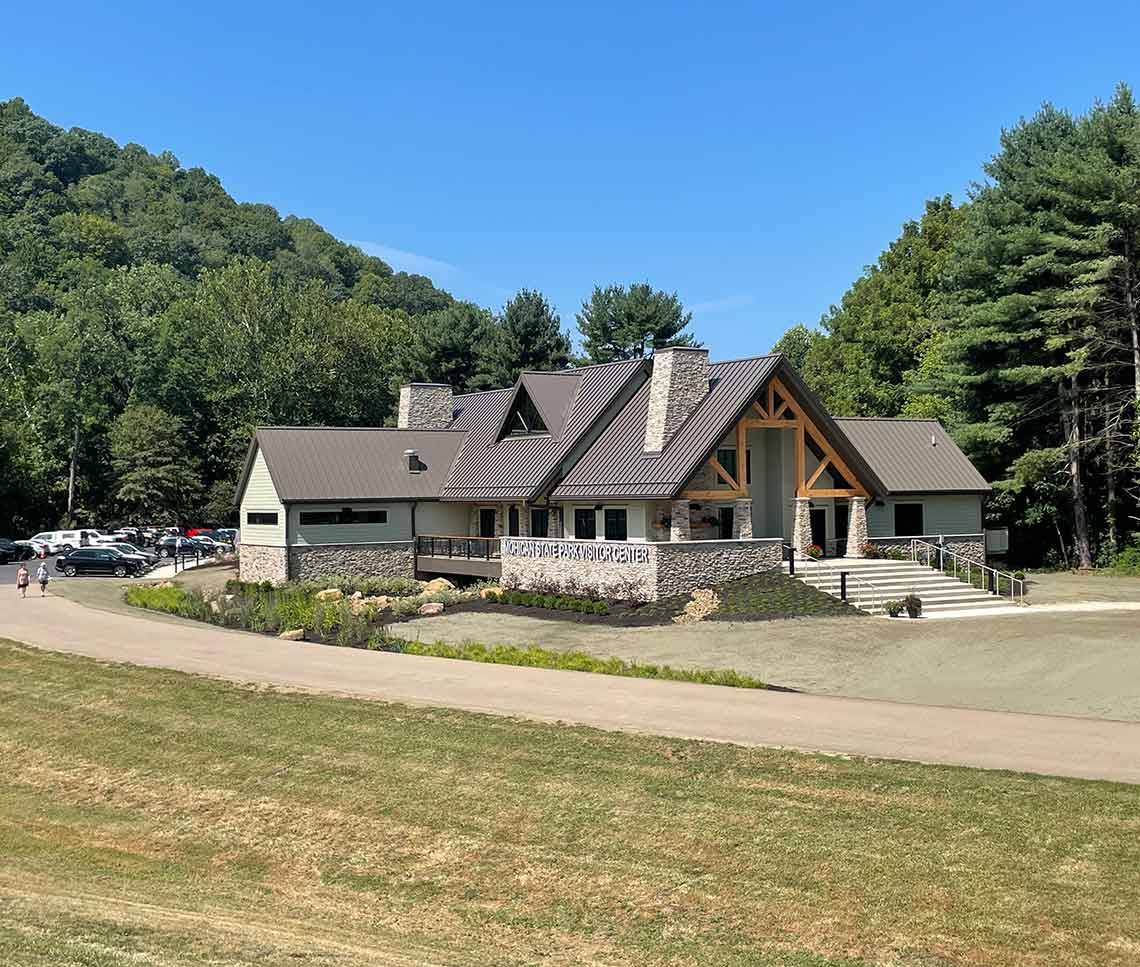 Visitor center entry with stone base and wood trusses
