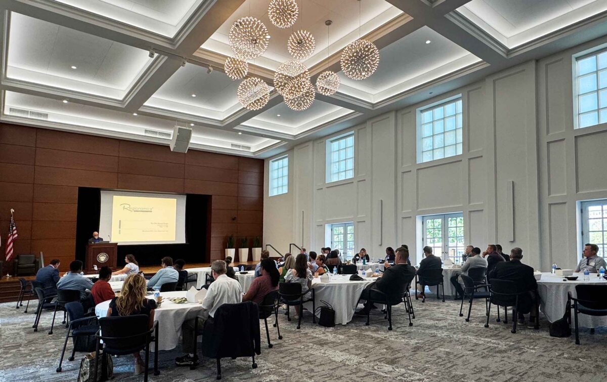 Contemporary university auditorium with speaker and audience