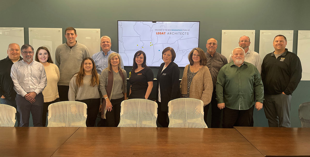 Staff of Legat Architects and Studio 3 Design lined up and smiling