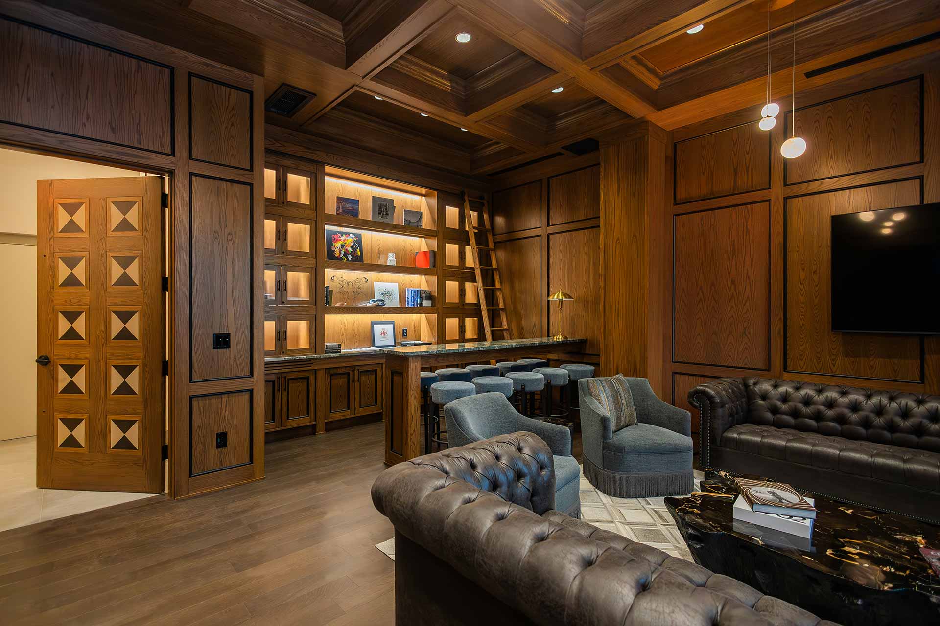 English sitting-room style hotel space with wood paneling and wood ceilings
