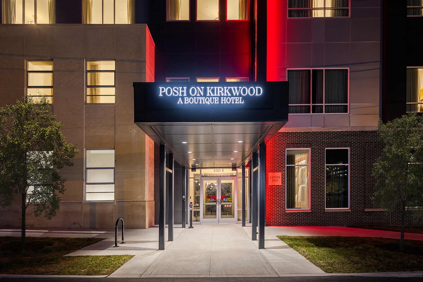 Hotel metal canopy entry with red lights in background