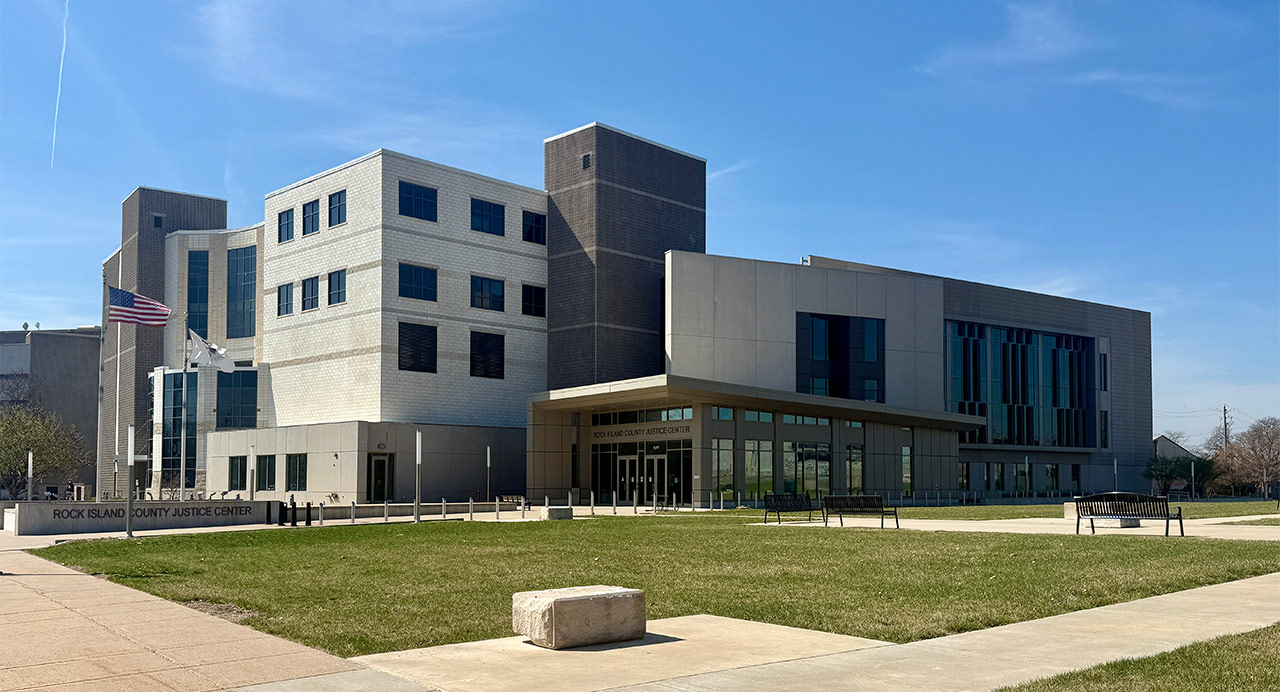 Exterior view of county building built with concrete blocks and glass entrance